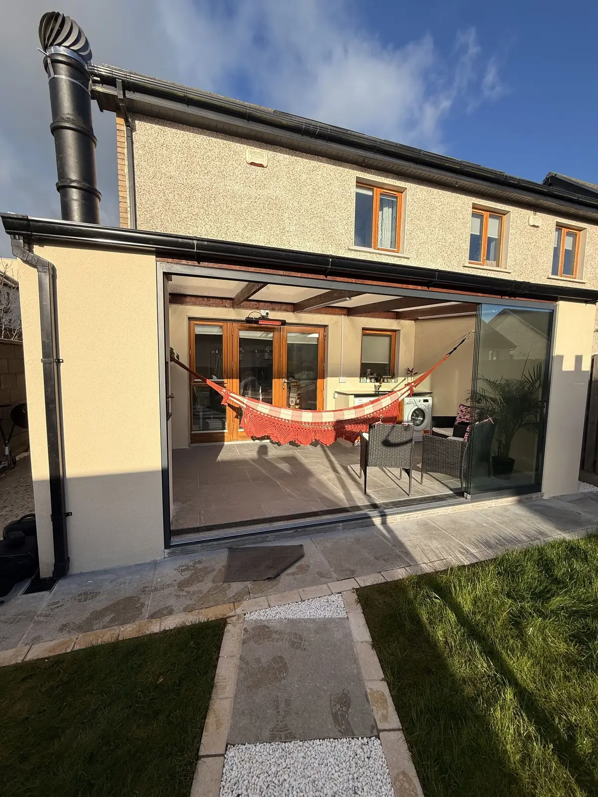 Covered outdoor room with glass sliding panels