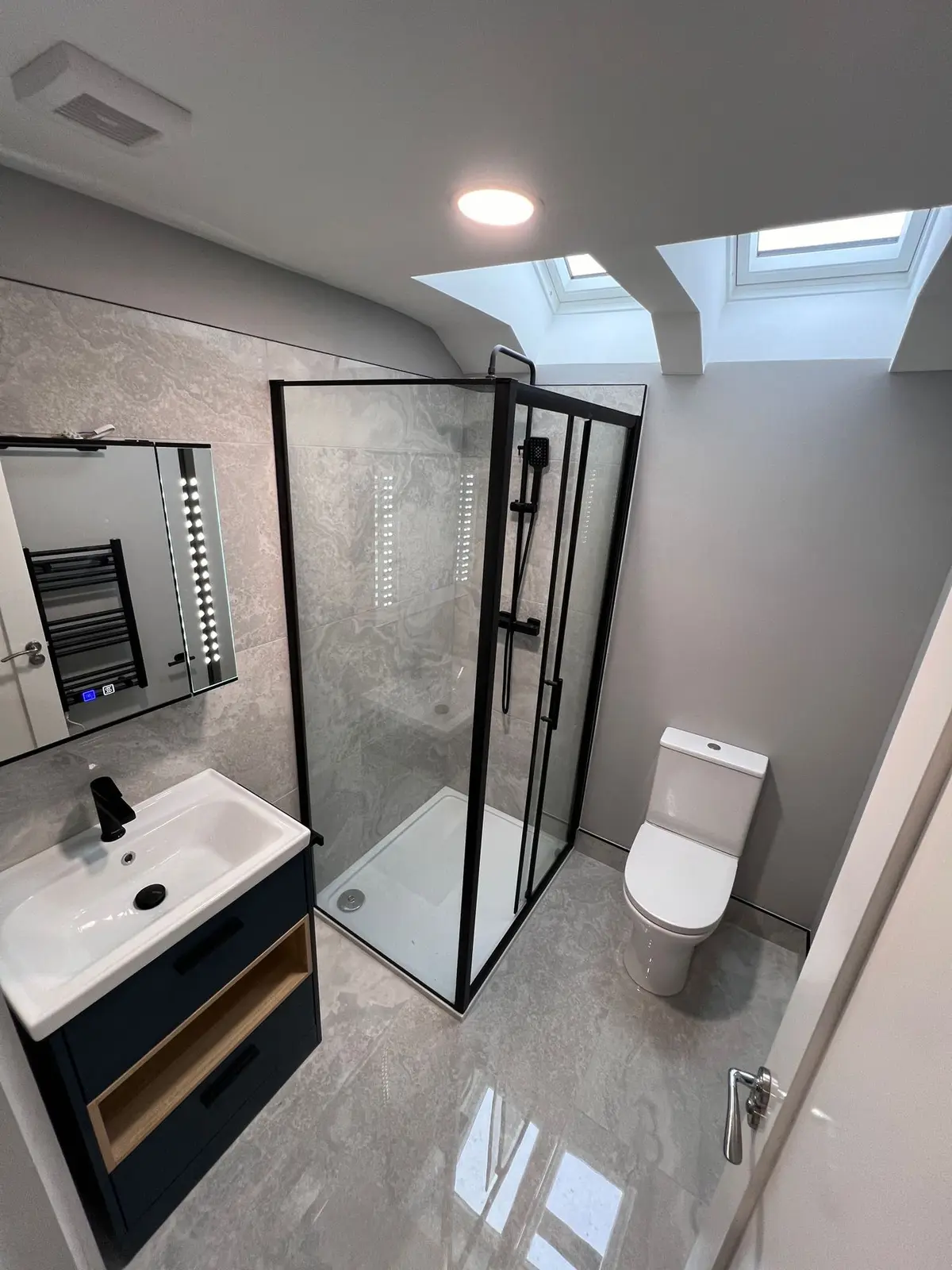 Attic shower room with black framed screen
