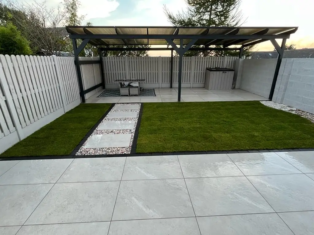Porcelain patio with a path through the lawn
