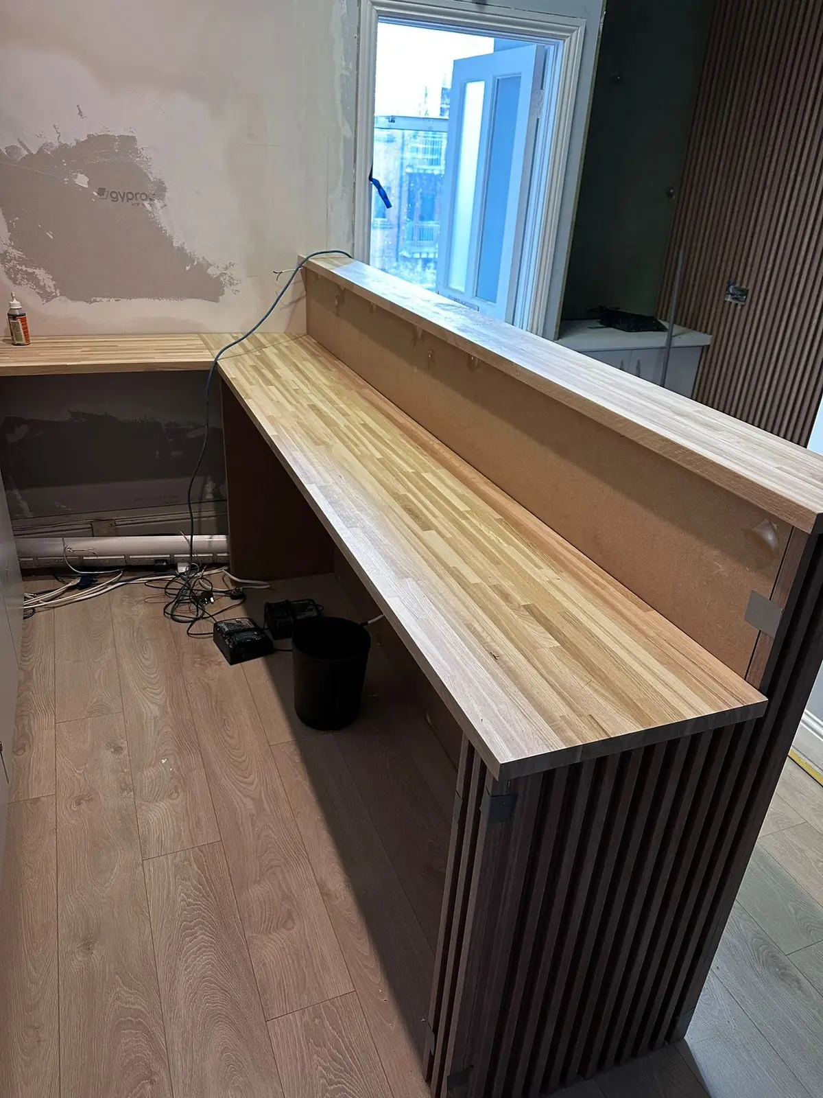 Reception desk carcass with timber top on site
