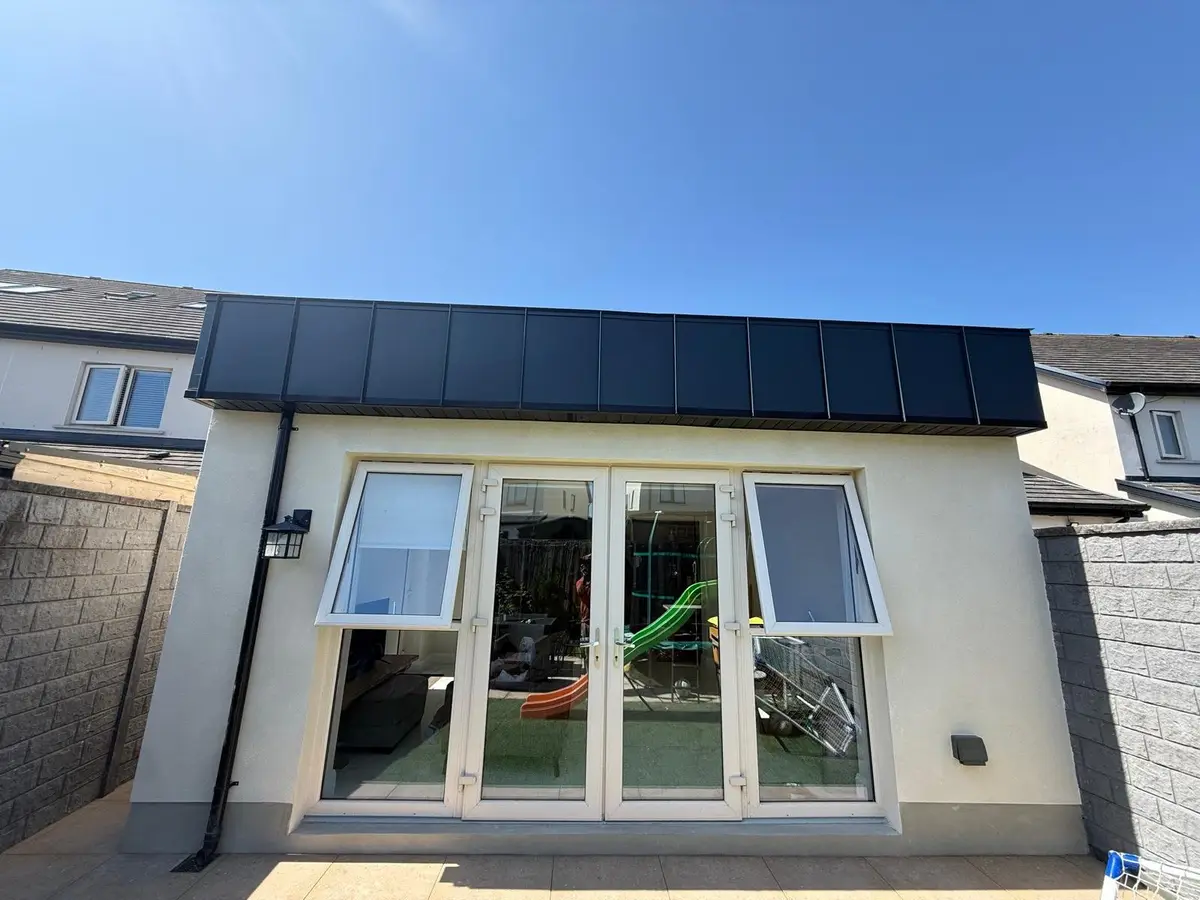 Finished rear extension with standing seam fascia and French doors