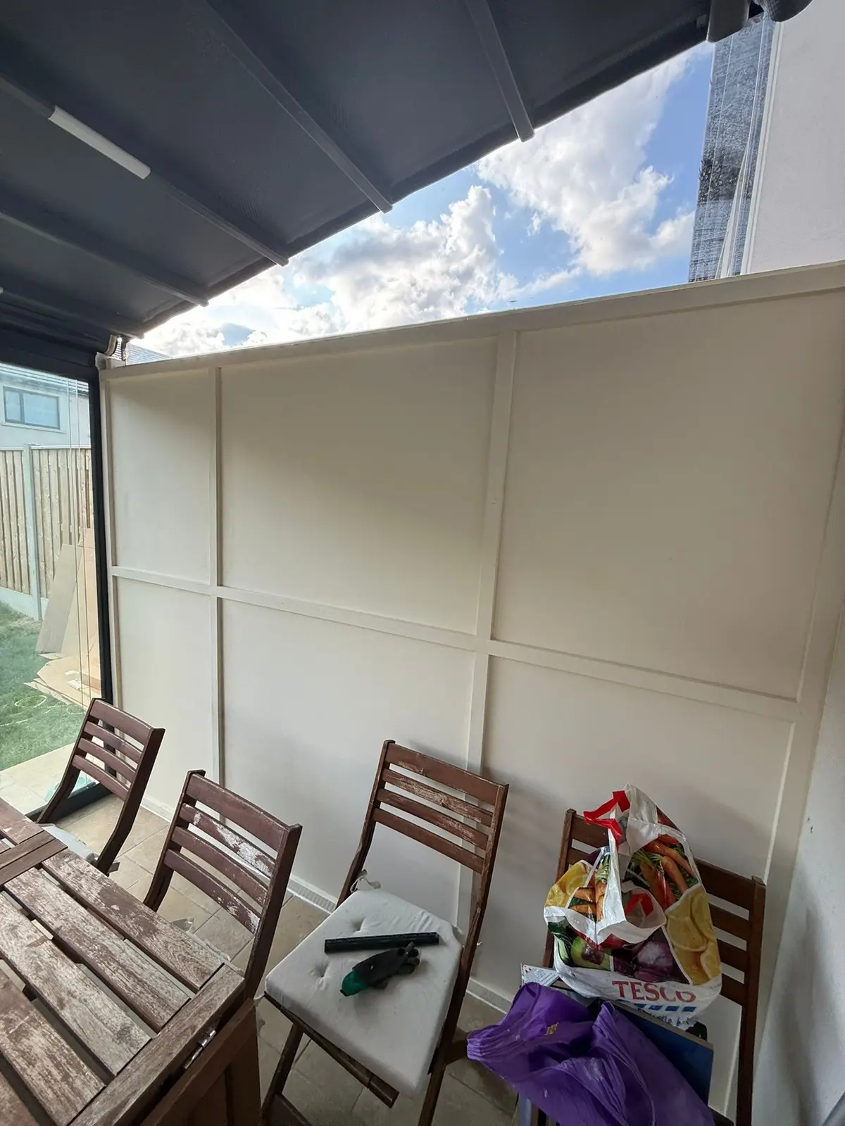 Panelled side wall inside the glass room