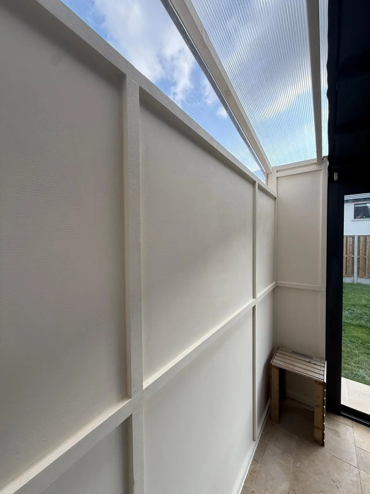 Panelled wall with a clear roof section above