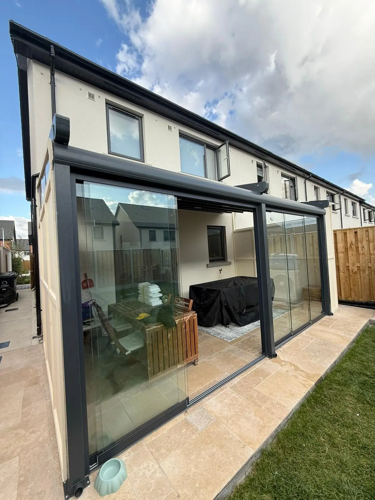 Glass room with sliding glass panels on the patio