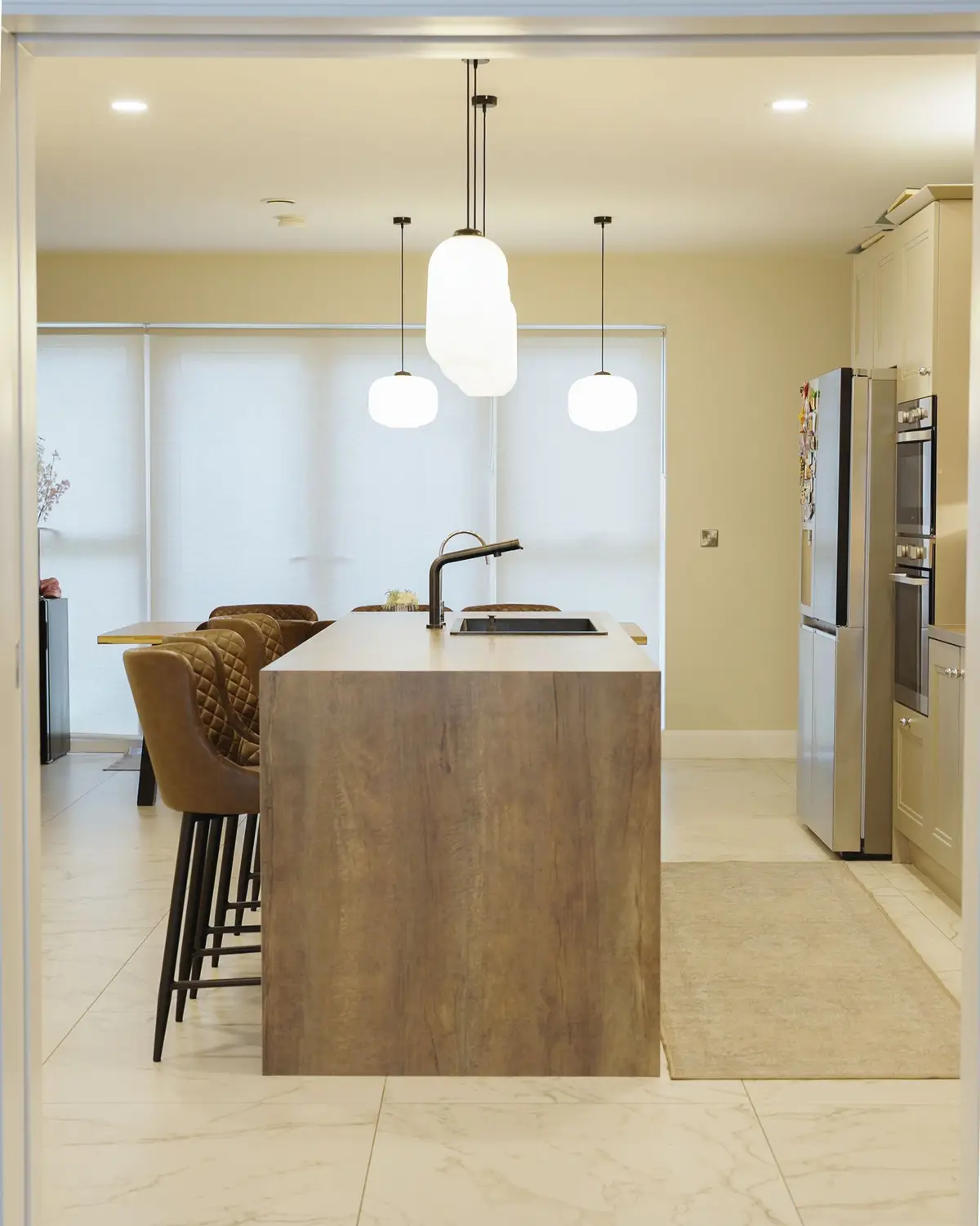 Kitchen island with pendants and full-height units