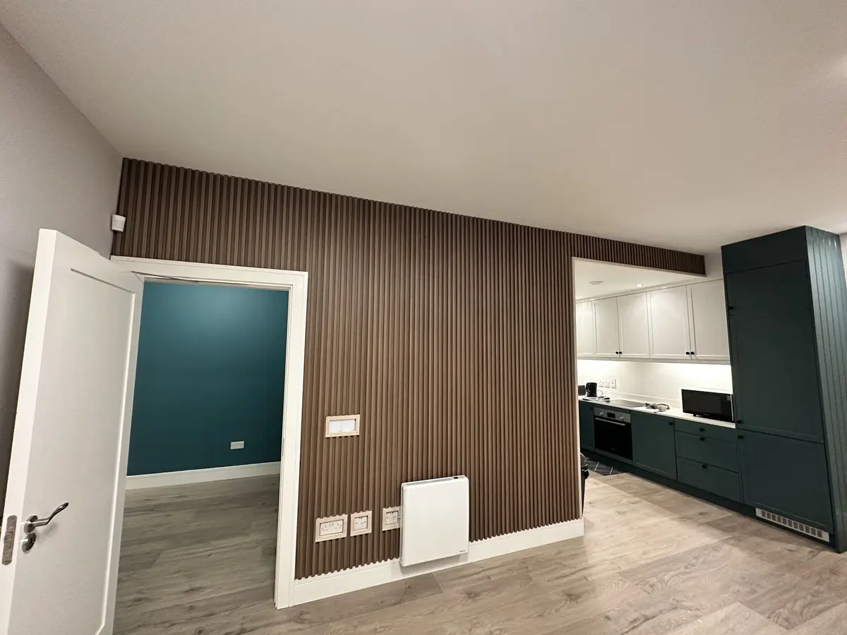 Slatted feature wall and green kitchen