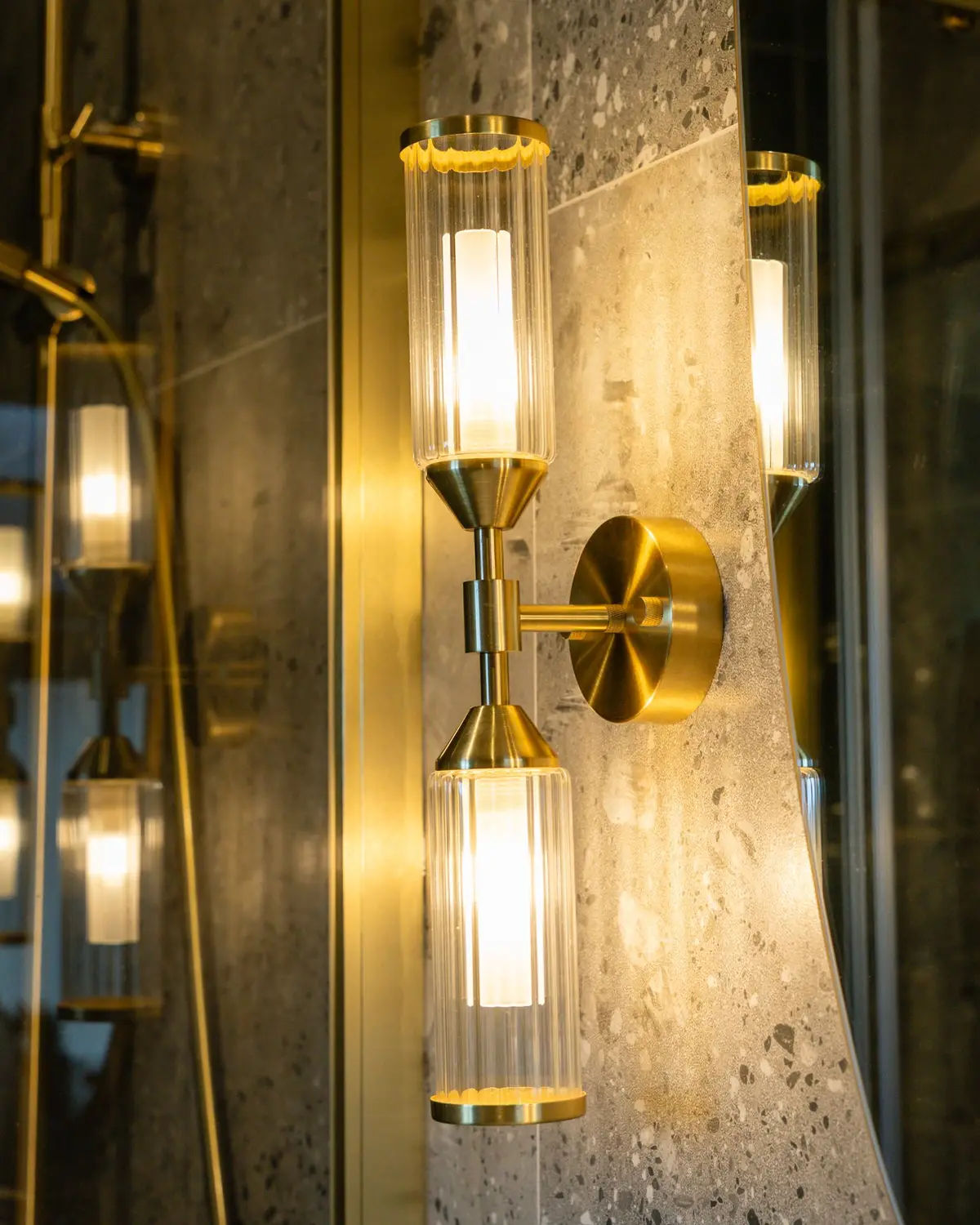 Brass wall light on stone tile