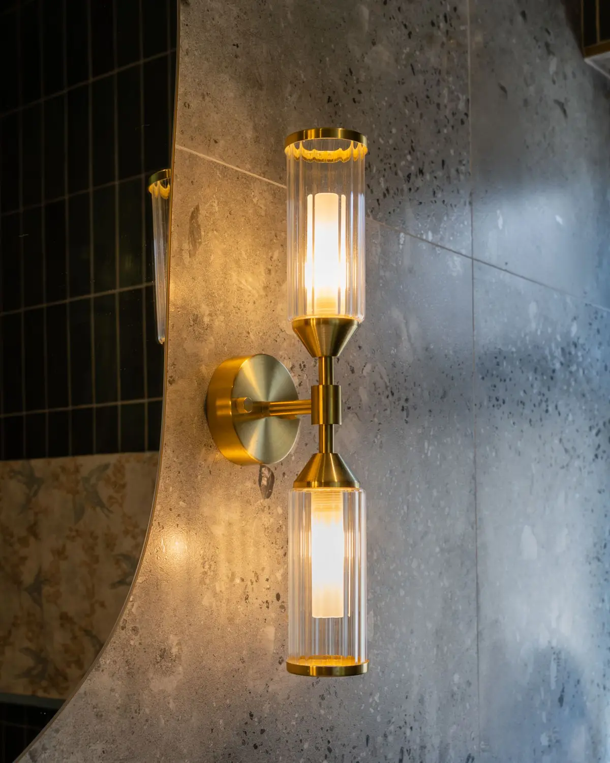 Brass wall light on stone tile