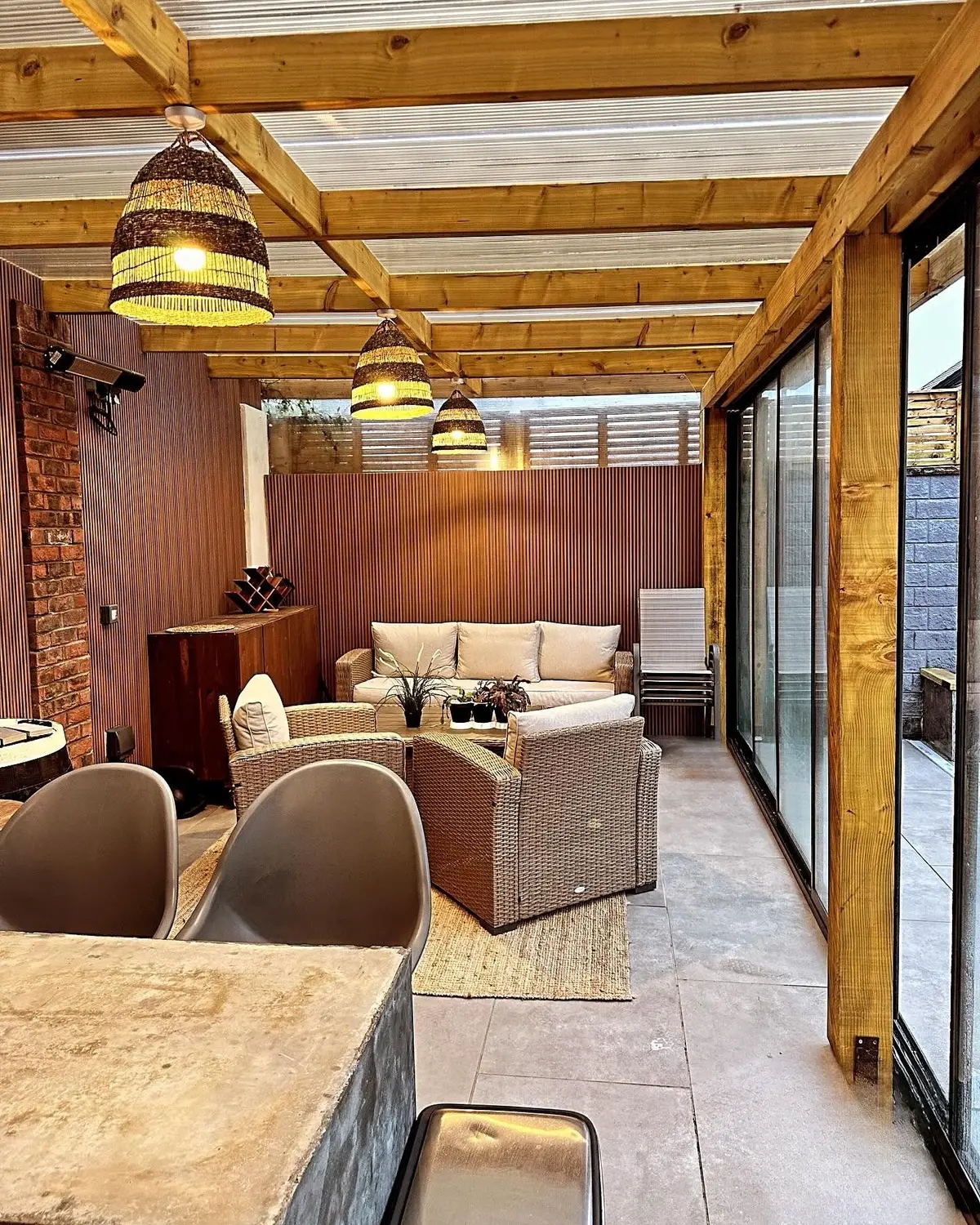 Inside the glazed room, lounge and timber roof