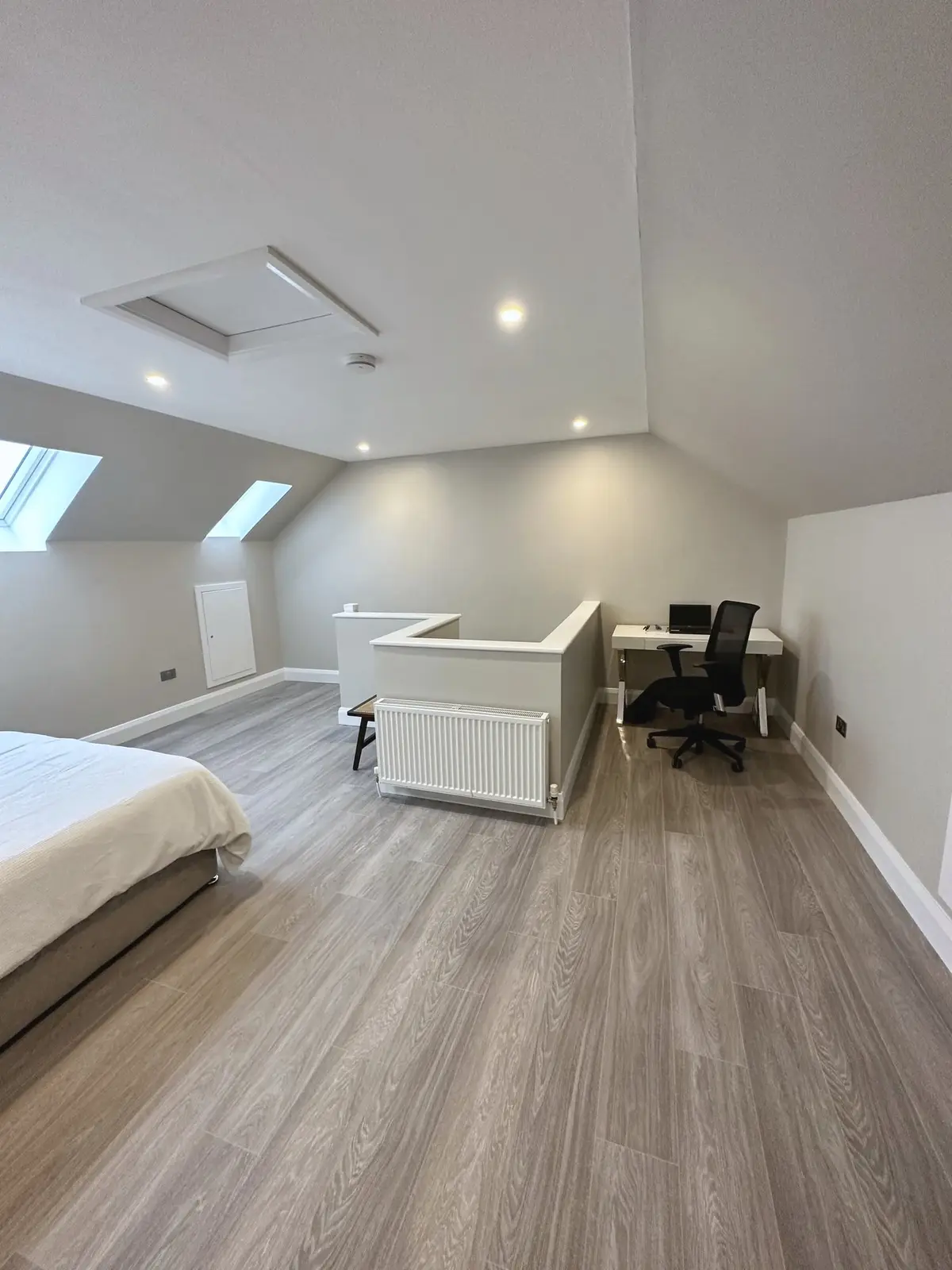 Attic bedroom with rooflights and study area