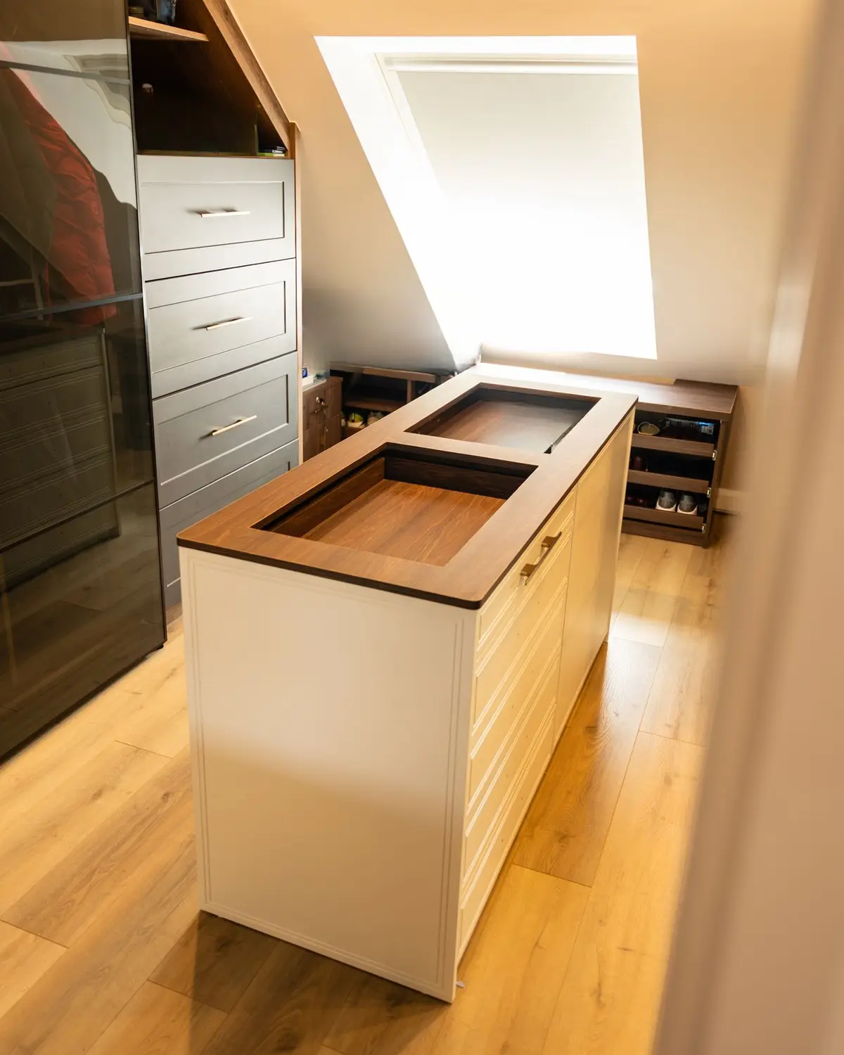 Attic dressing room with island unit and eaves wardrobes