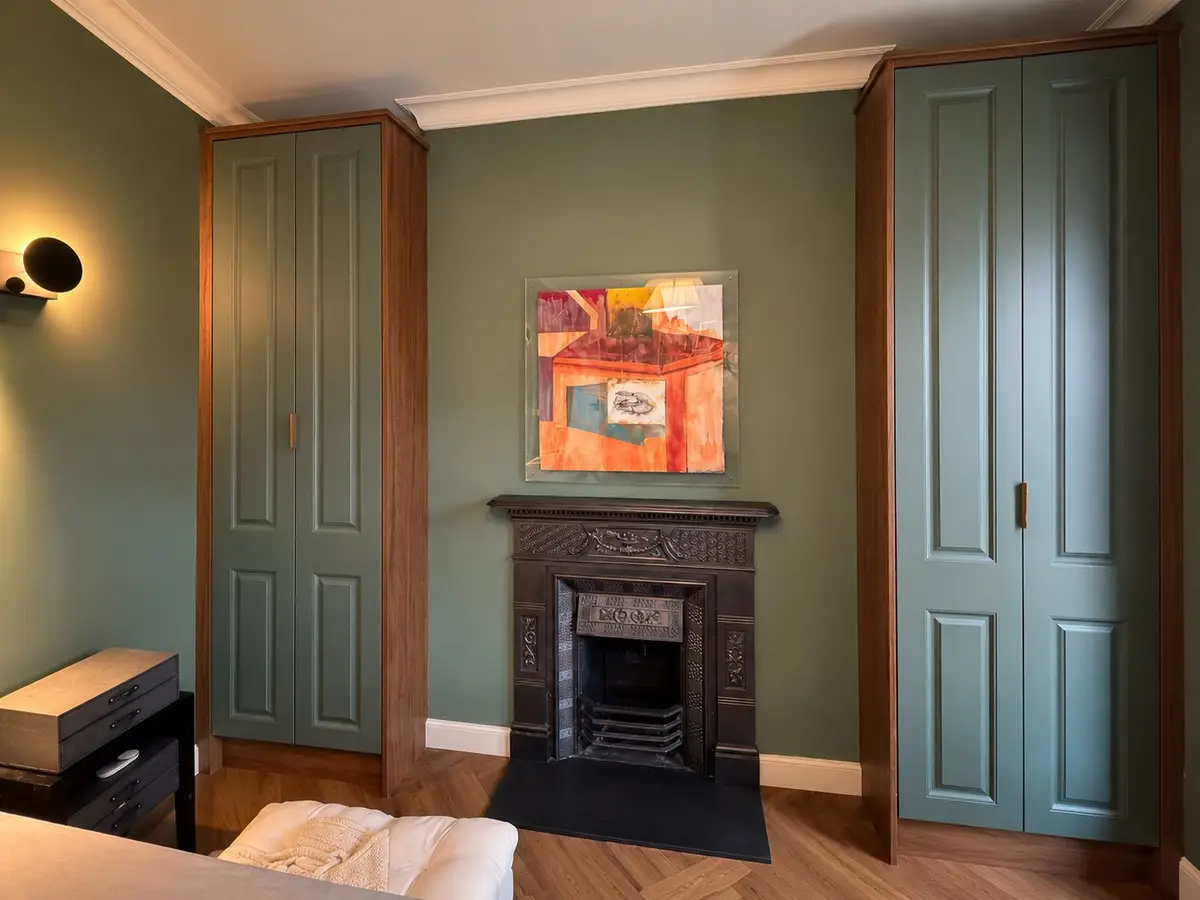 Panelled wardrobes either side of a fireplace, Drumcondra