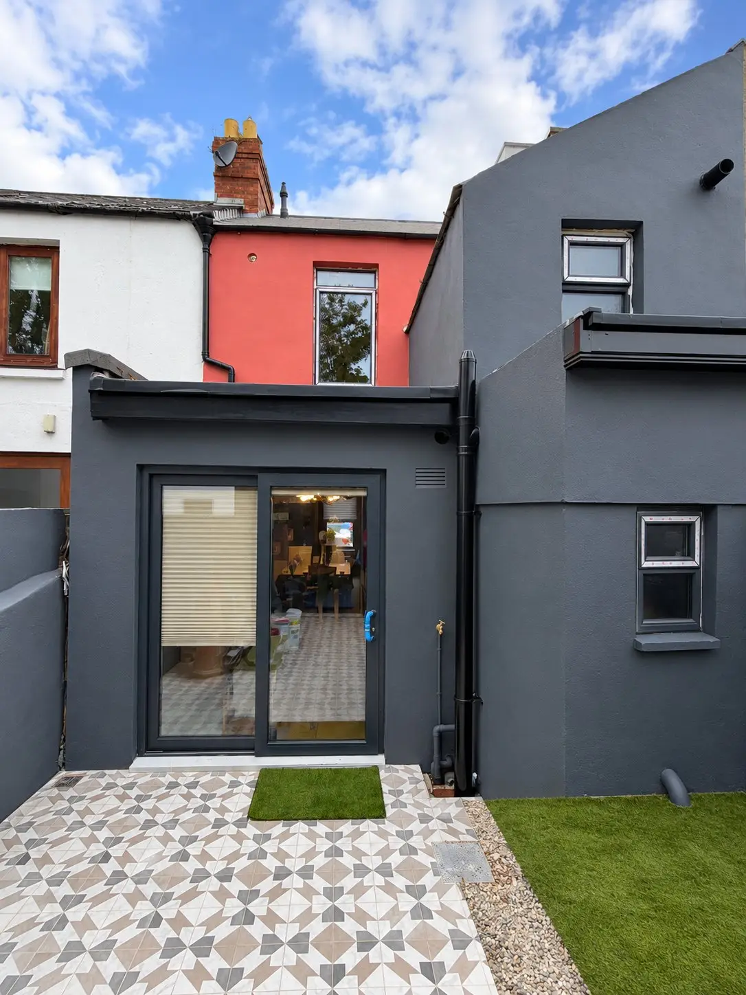 The same view after: new rear extension, patio and lawn