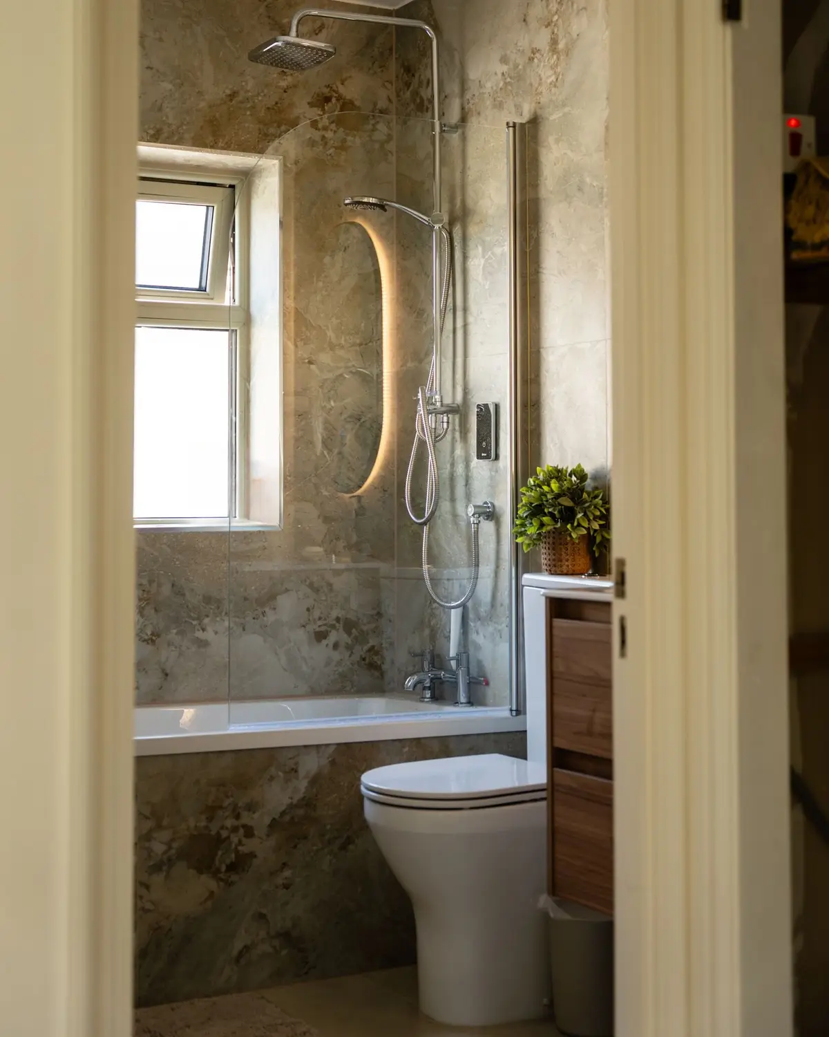 Bathroom with stone look tile and oval mirror