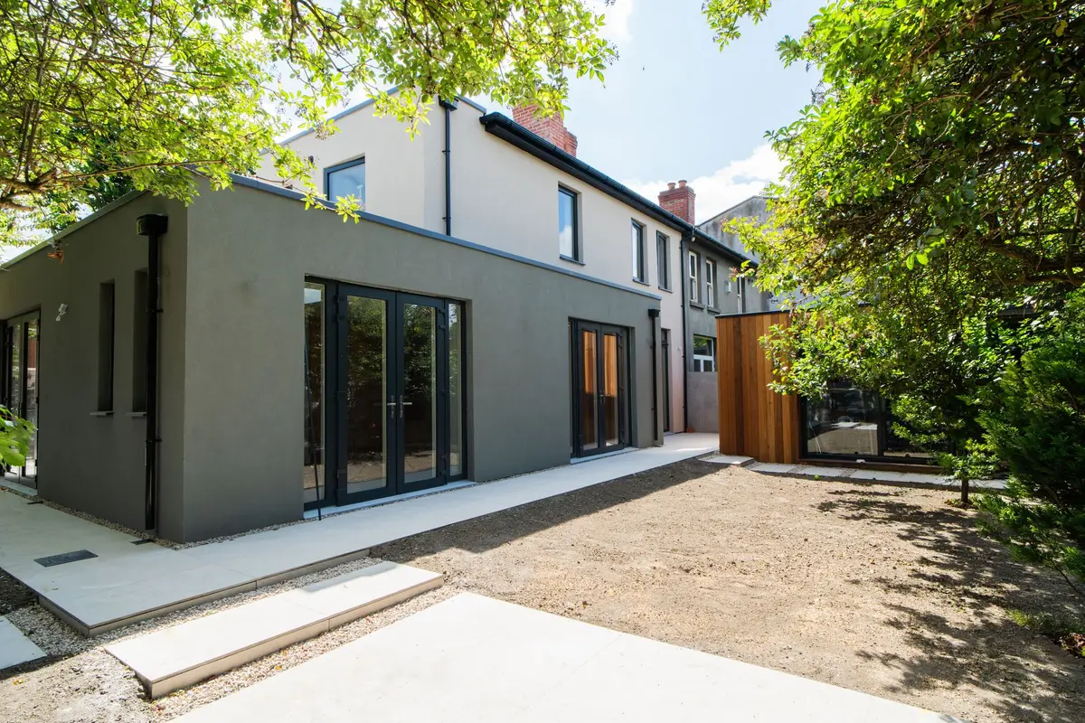 Finished rear extension, render and full-height glazing