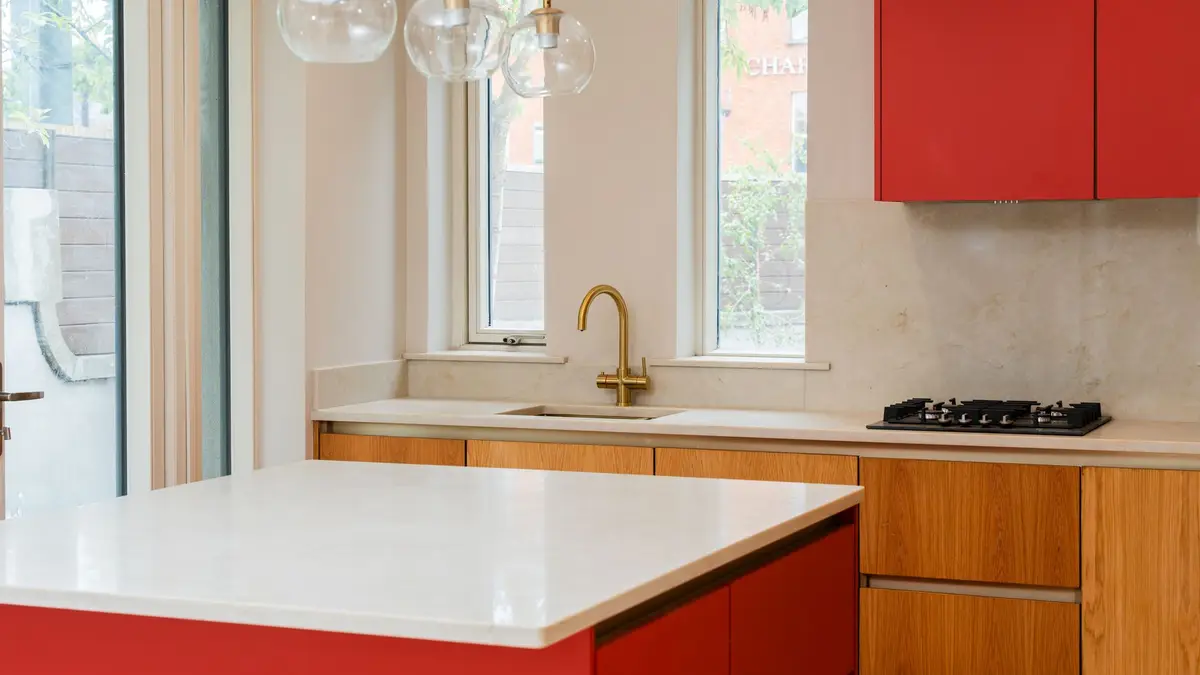 Kitchen with brass tap and stone worktop