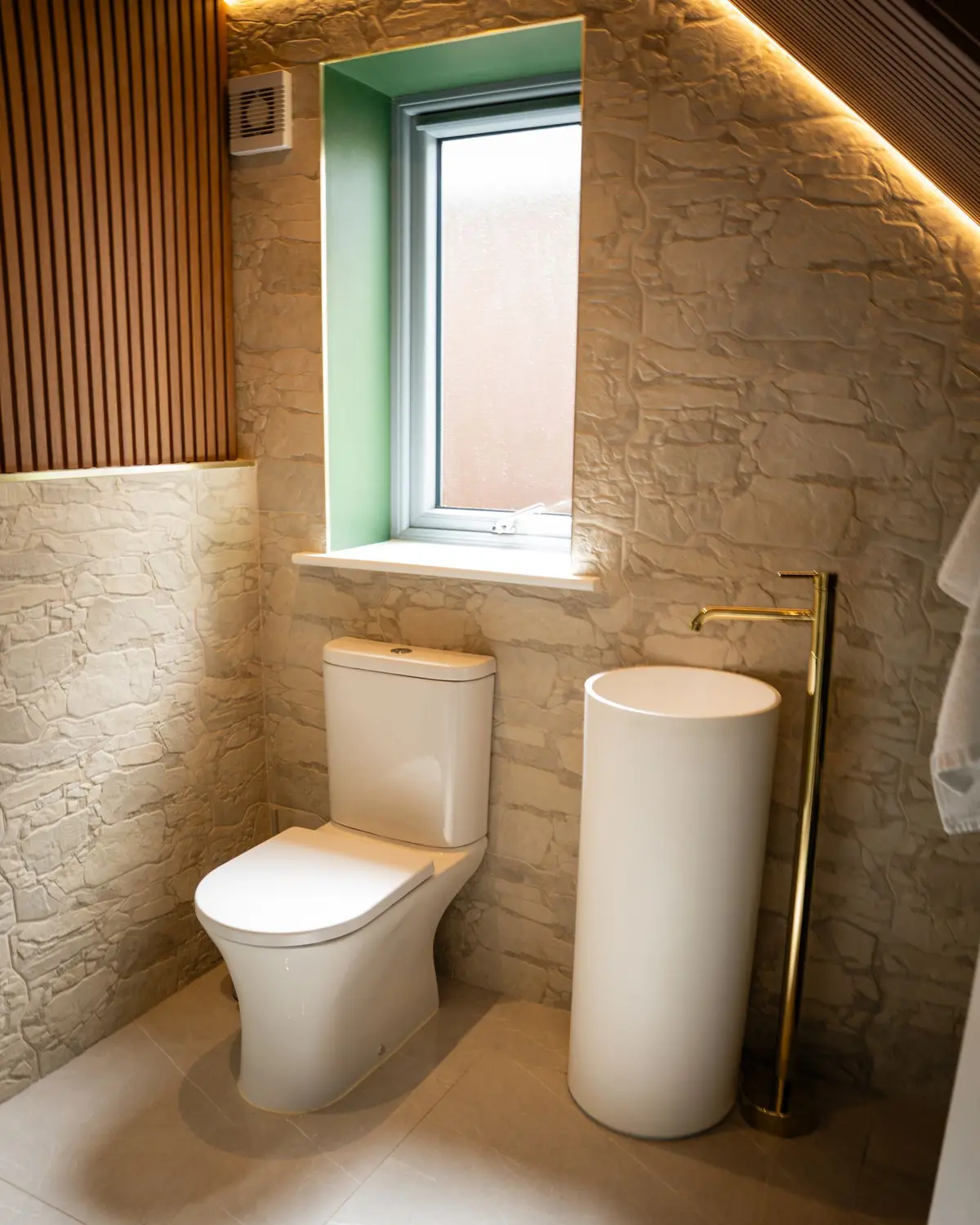 WC with stone wall and fluted timber